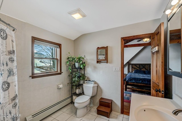 bathroom with a baseboard heating unit, tile walls, toilet, tile patterned floors, and lofted ceiling