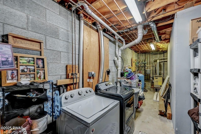 unfinished basement with washer and dryer and a water pressure tank