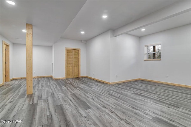 basement with light hardwood / wood-style flooring