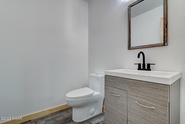 bathroom featuring hardwood / wood-style floors, vanity, and toilet