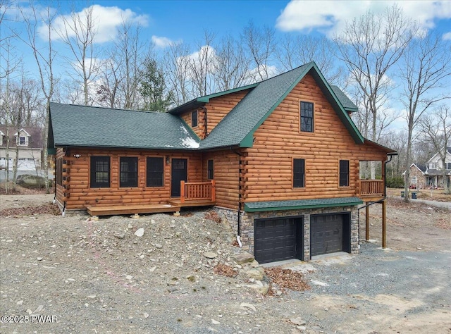 log-style house with a garage