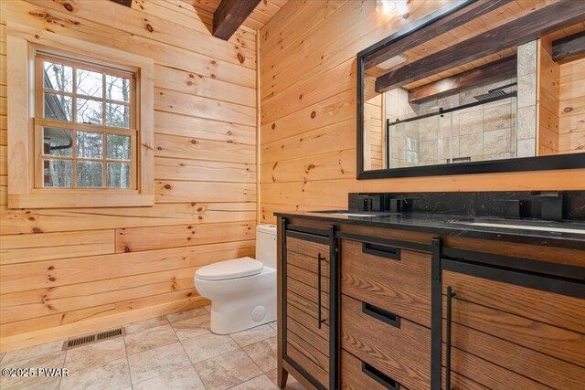 bathroom featuring beam ceiling, tile patterned flooring, wood walls, an enclosed shower, and vanity