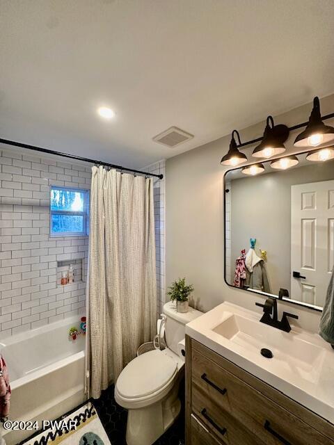 full bathroom featuring shower / tub combo, vanity, and toilet