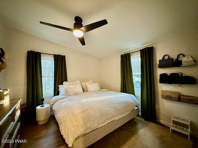 bedroom featuring ceiling fan and dark wood-type flooring