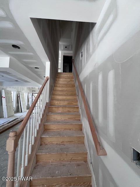 staircase with hardwood / wood-style flooring