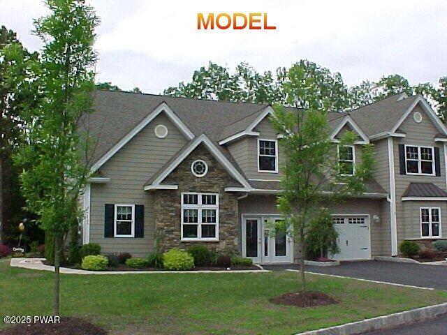 craftsman-style home with a garage and a front yard