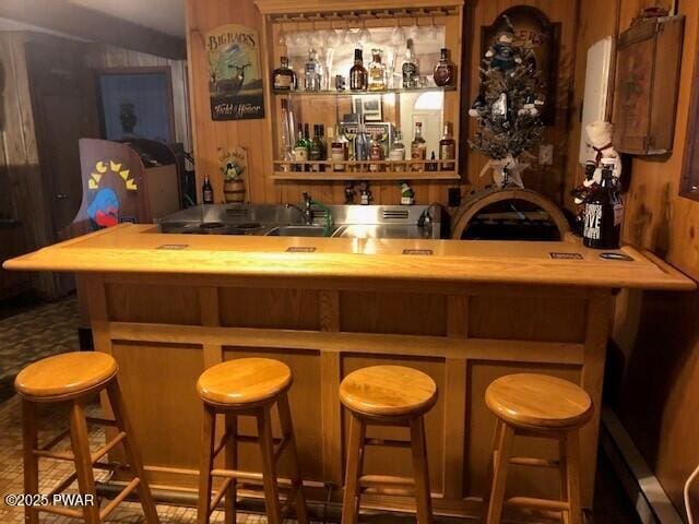 bar with sink and wooden walls