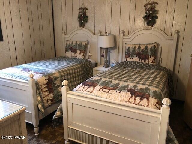 bedroom with wood walls