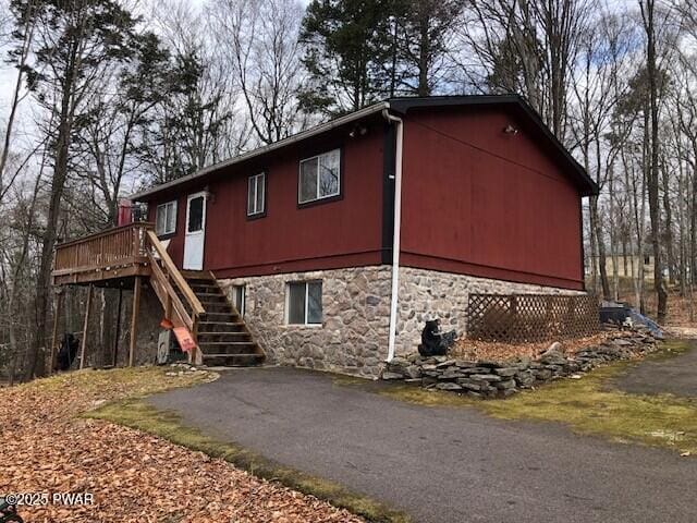 view of side of property featuring a deck