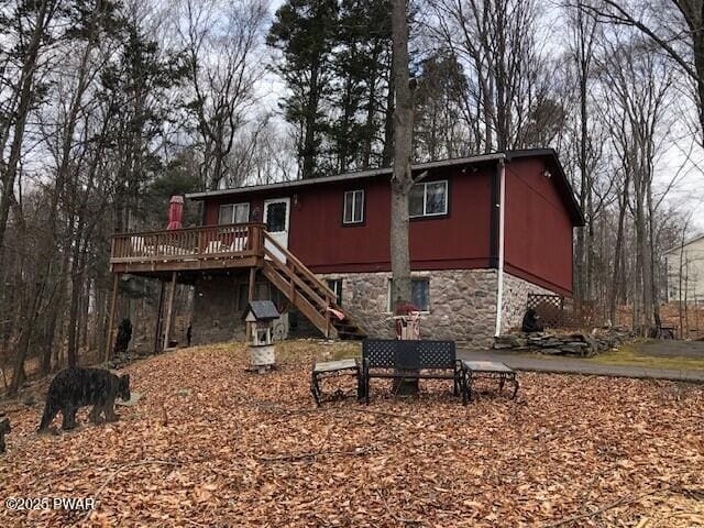 back of house with a deck