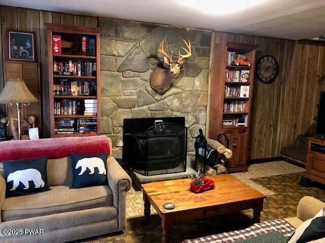 living room with wood walls and built in features