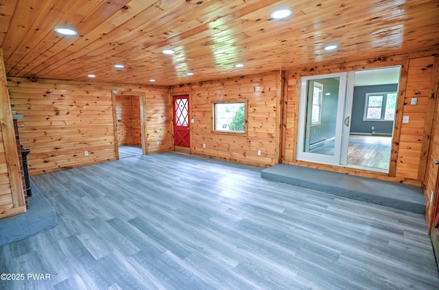 unfurnished room with recessed lighting, wood walls, wood finished floors, and wood ceiling