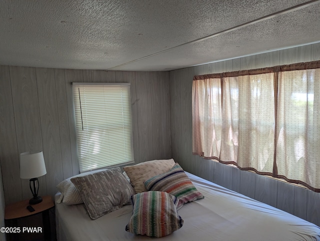 150 Shohola Pkwy N, Shohola, PA 18458 - bedroom featuring multiple windows, wood walls, and a textured ceiling