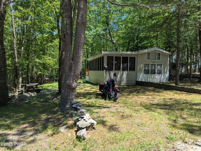 150 Shohola Pkwy N, Shohola, PA 18458 - view of front of property featuring a sunroom and a front yard