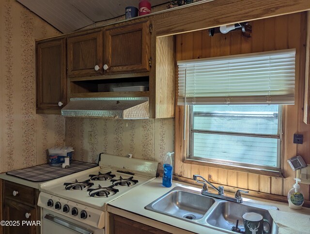 150 Shohola Pkwy N, Shohola, PA 18458 - kitchen with white gas stove, wallpapered walls, exhaust hood, and light countertops