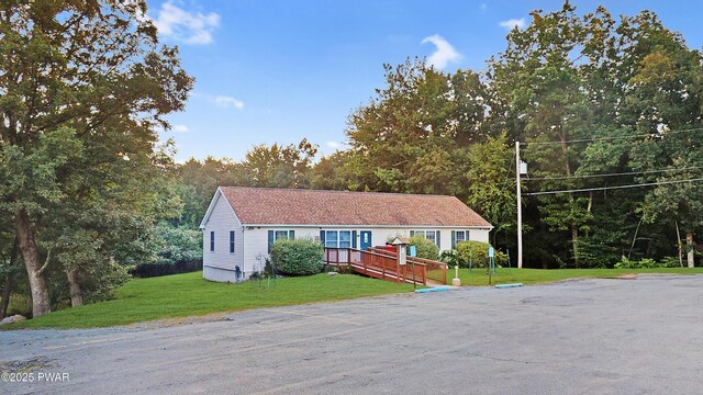 150 Shohola Pkwy N, Shohola, PA 18458 - ranch-style home with a front lawn and a wooden deck