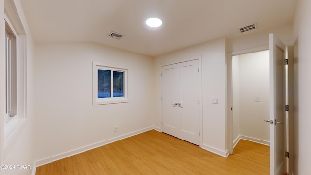 unfurnished bedroom featuring a closet and light wood-type flooring