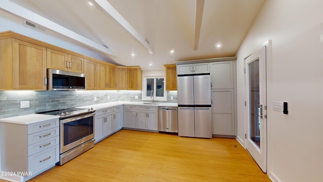 kitchen featuring vaulted ceiling with beams, light hardwood / wood-style floors, sink, and appliances with stainless steel finishes