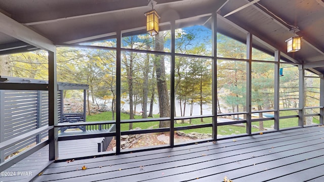 unfurnished sunroom featuring vaulted ceiling