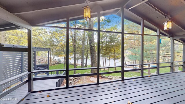 unfurnished sunroom with lofted ceiling