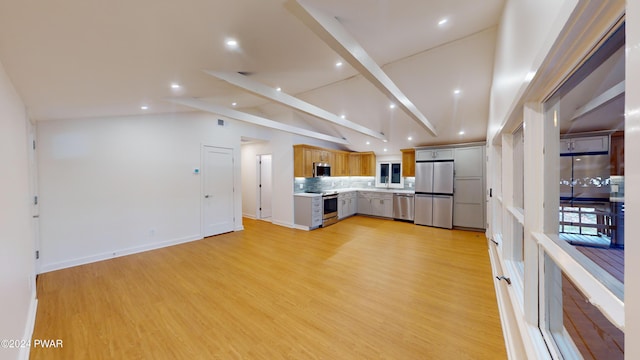 kitchen featuring appliances with stainless steel finishes, backsplash, light hardwood / wood-style floors, and vaulted ceiling with beams