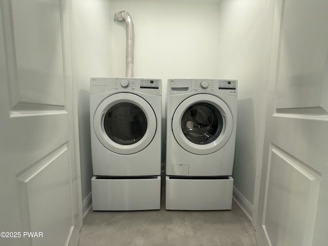 clothes washing area featuring independent washer and dryer