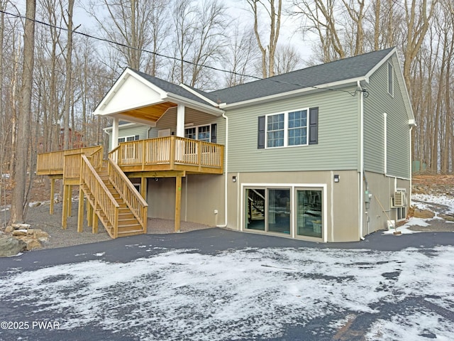 snow covered property featuring a deck