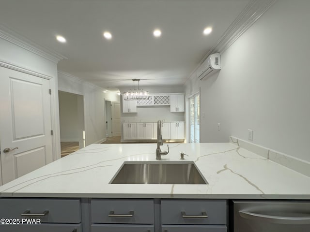 kitchen featuring sink, stainless steel dishwasher, a wall unit AC, and light stone counters