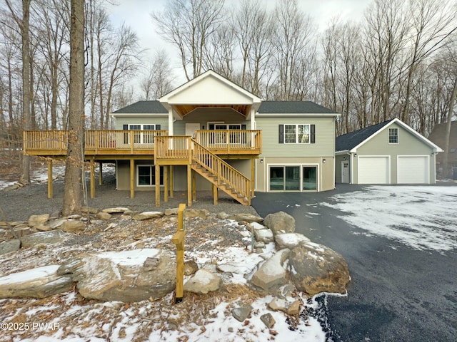 view of front of house with a garage and a deck