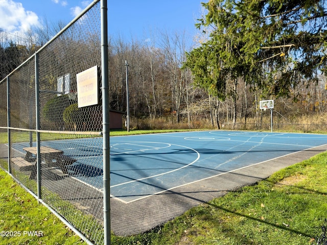 view of sport court with a lawn