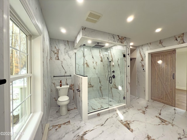 bathroom featuring toilet and a shower with shower door