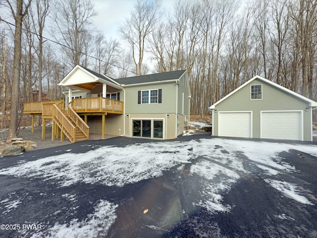 view of front of house featuring an outdoor structure, a wooden deck, and a garage