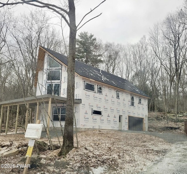 back of house with a garage