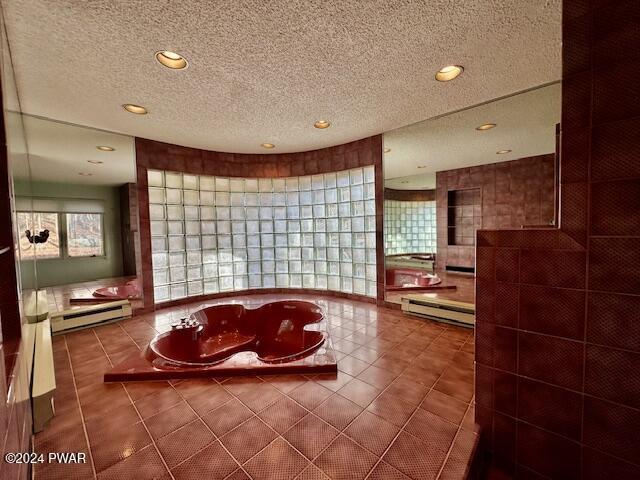 bathroom featuring tile patterned flooring, a textured ceiling, and a baseboard radiator