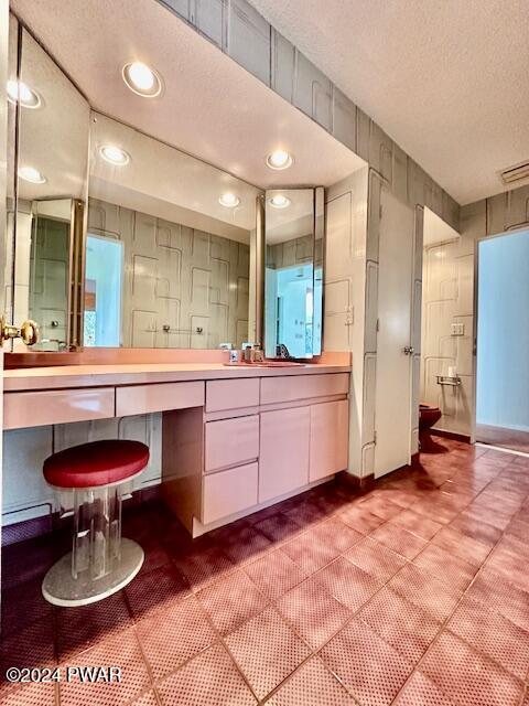 bathroom featuring vanity and a textured ceiling