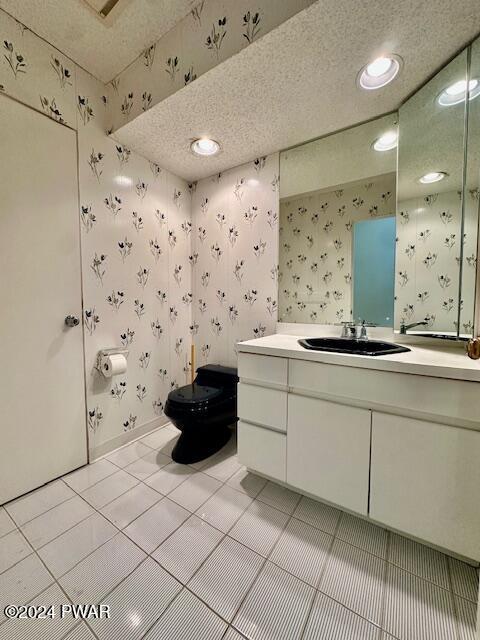 bathroom featuring tile patterned flooring, vanity, and toilet