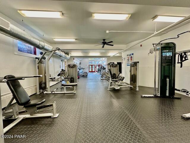 exercise room with ceiling fan