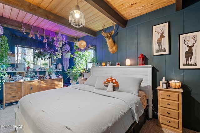 carpeted bedroom featuring beam ceiling and wooden ceiling