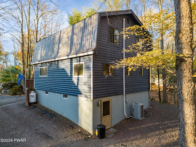 view of side of home featuring cooling unit