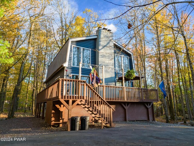 view of front facade with a garage and a wooden deck