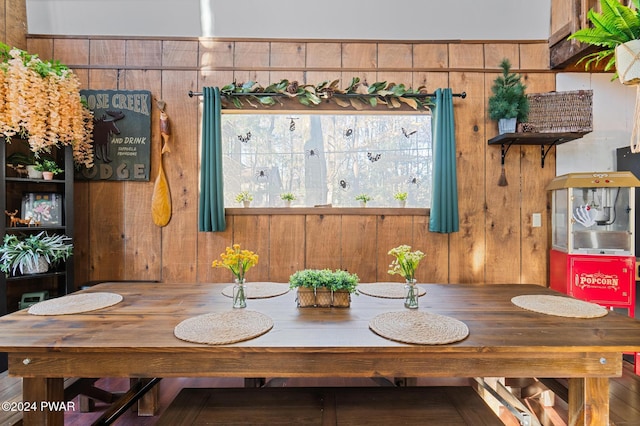 dining space featuring wood walls