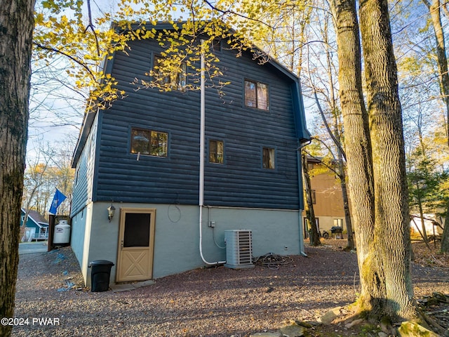 back of property with central AC unit