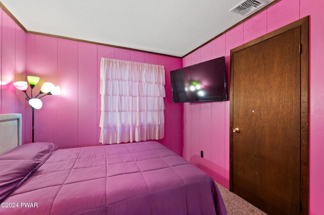 unfurnished bedroom with carpet and a textured ceiling