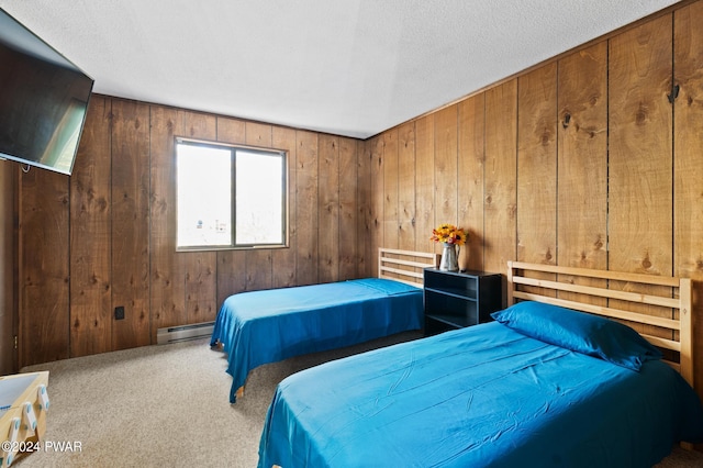 carpeted bedroom featuring a textured ceiling, baseboard heating, and wooden walls