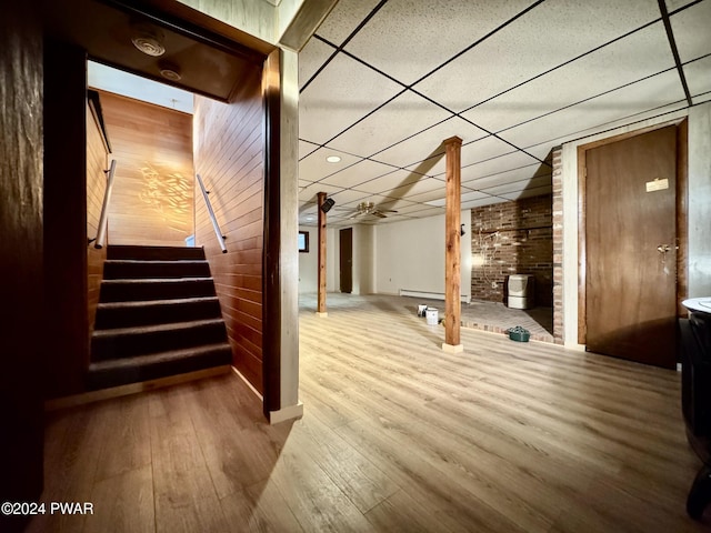 bonus room with wooden walls and hardwood / wood-style flooring