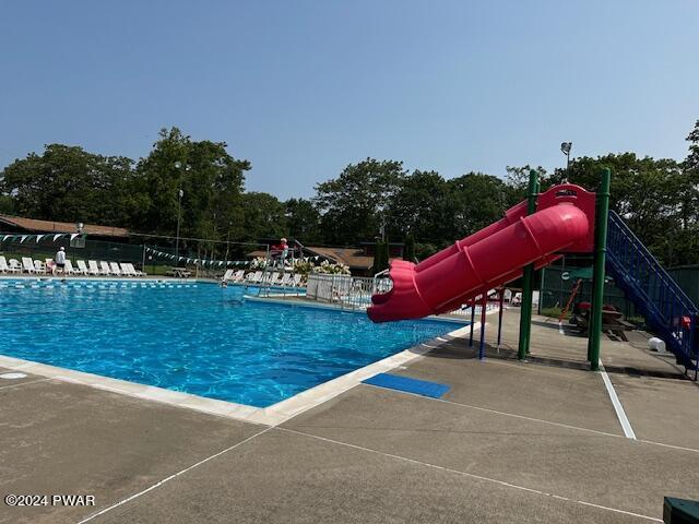 view of pool featuring a patio and a water slide