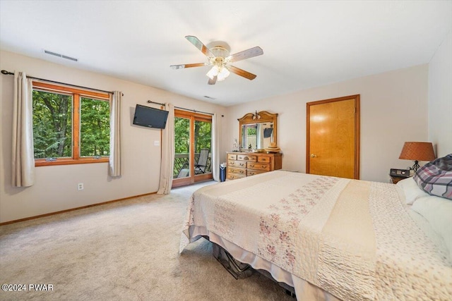 bedroom with access to exterior, ceiling fan, and carpet floors