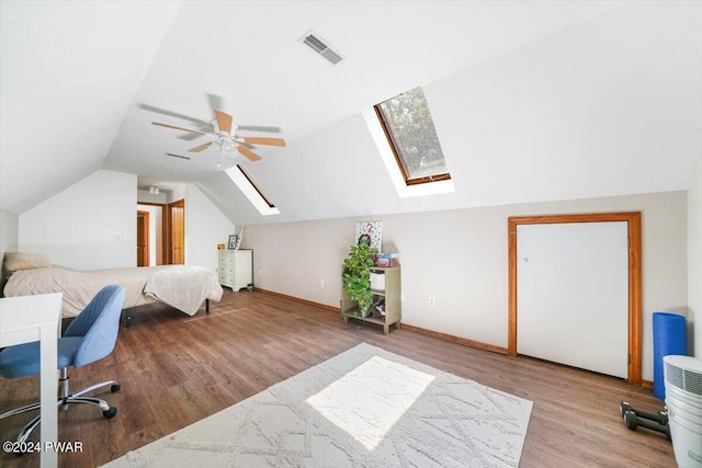 office area featuring ceiling fan, light wood-type flooring, and lofted ceiling with skylight