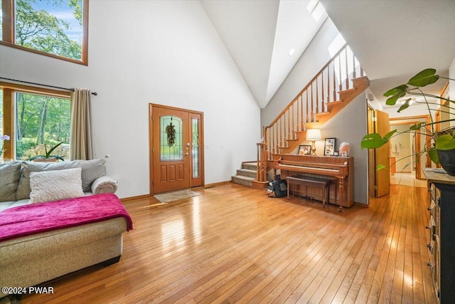 entrance foyer with light wood-type flooring and a high ceiling