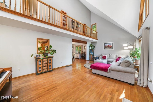 living room featuring hardwood / wood-style floors and a towering ceiling